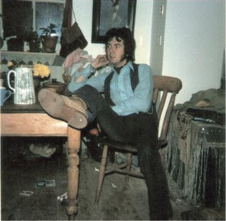 JFAM Photo - pg 33 Ronnie Lane Relaxing Inside at  Fishpool Farm Foot on Table year- Photo Credit-