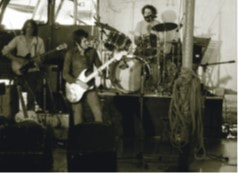 JFAM Photo - pg 59 Ronnie Lane on stage Slim Chance Passing Show BW photo credit-